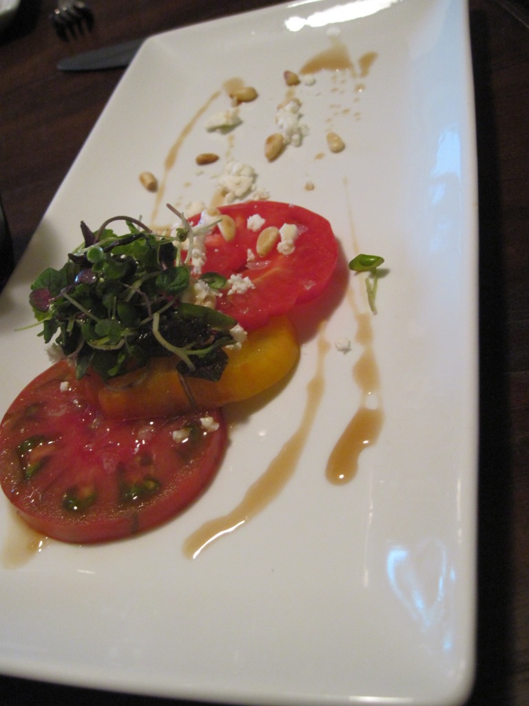 Heirloom tomato salad with sherry gastrique, toasted pine nuts, goat cheese and microgreens